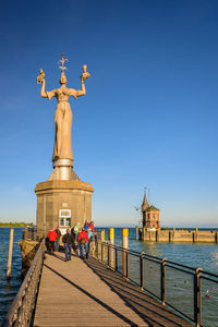 Statue in front of sea