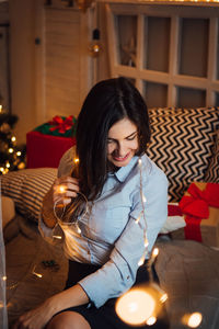 Young woman sitting at home