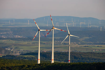 Traditional windmill on field against sky