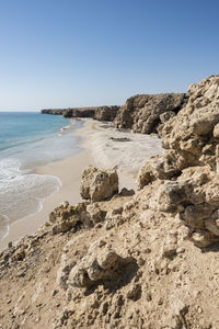 Wild beach at the coat of ras al jinz with copy space in the blue sky, sultanate of oman.