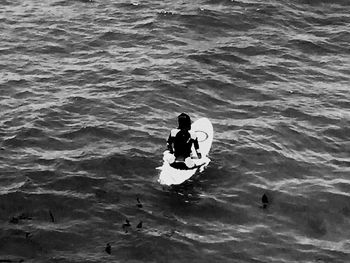 High angle view of man sitting in sea