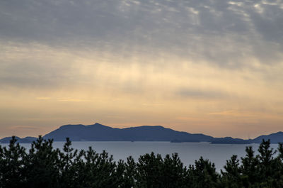 Scenic view of silhouette mountains against sky at sunset
