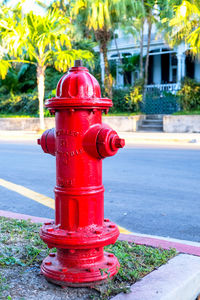 Red fire hydrant on sidewalk in city