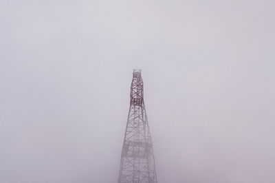 Low angle view of communications tower against sky