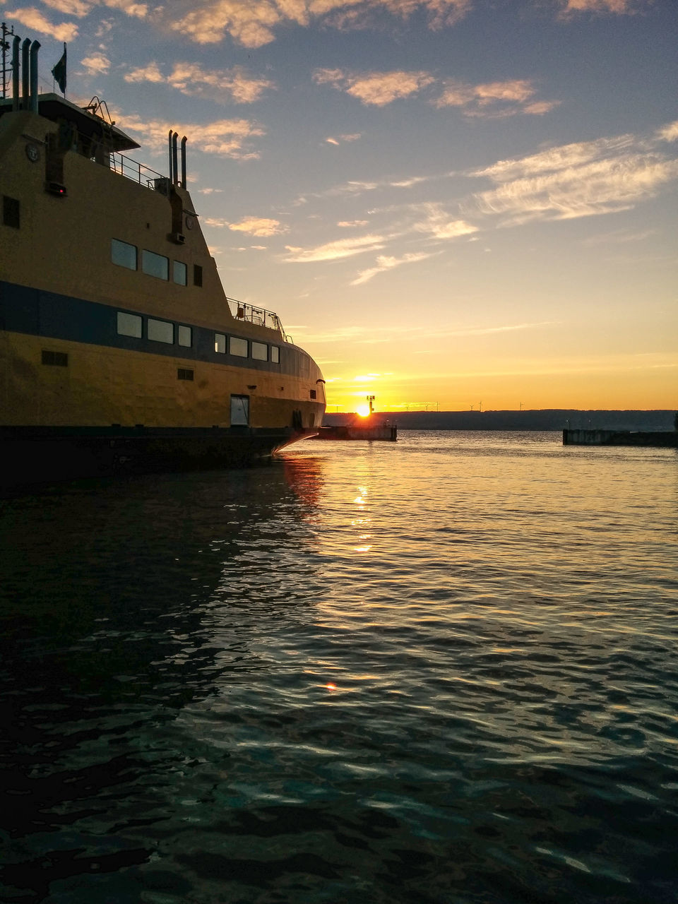 water, sunset, architecture, built structure, waterfront, building exterior, sky, sea, rippled, reflection, orange color, cloud - sky, scenics, transportation, beauty in nature, nature, outdoors, tranquility, tranquil scene, no people