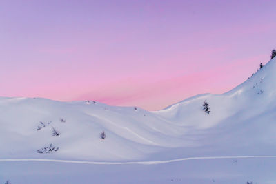 Scenic view of snowcapped mountains against sky during sunset