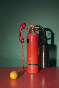 Close-up of telephone booth on table against wall