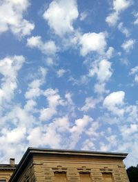 Low angle view of building against cloudy sky