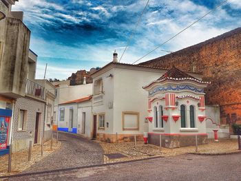 Houses against cloudy sky