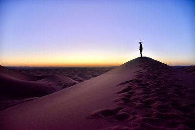 Scenic view of desert against sky during sunset