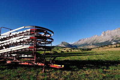 Built structure on field against clear blue sky