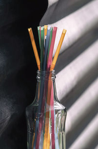 Close-up of colored pencils on glass table