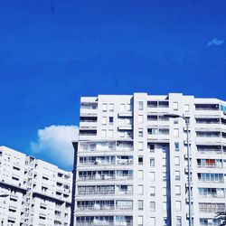 Low angle view of residential buildings against blue sky