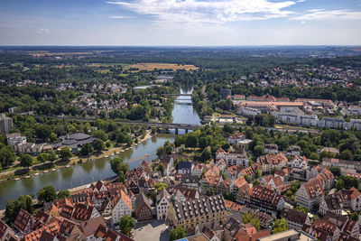 High angle view of townscape by river against sky