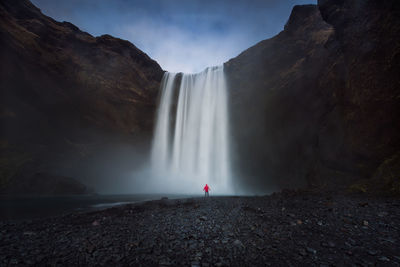 Low angle view of waterfall against sky