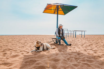 Man with arms outstretched on beach