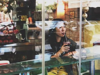 Young woman using mobile phone at store