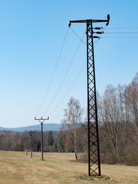 Power line towers against sky background. old fashion electric poles against blue sky, rusty metal