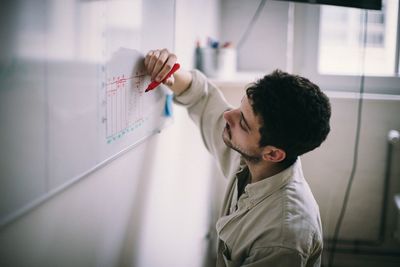 Side view portrait of man working at home