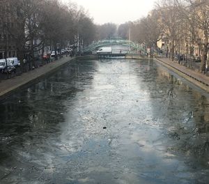 Wet bridge over canal in city during rainy season