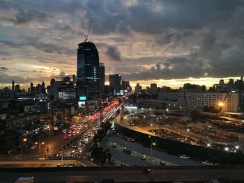 High angle view of illuminated buildings against sky at sunset