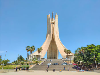 Low angle view of eiffel tower against clear blue sky