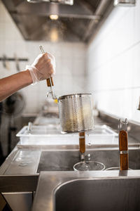 Cropped hand preparing food in kitchen