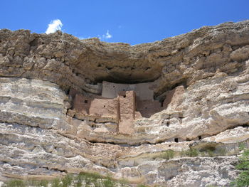 Low angle view of rock formation against sky