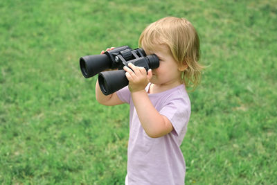 Young woman photographing with camera