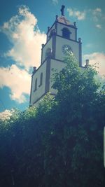 Low angle view of clock tower against sky