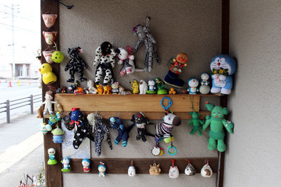 Various toys on table against wall