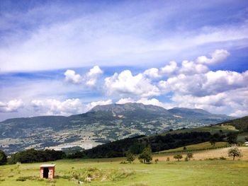 Scenic view of landscape against cloudy sky