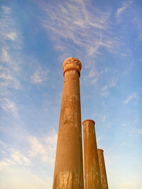 Low angle view of smoke stack against sky