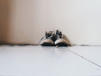 Shoes on floor against wall at home