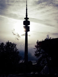 Low angle view of tower against cloudy sky