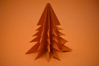 Low angle view of christmas tree against orange sky