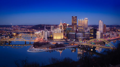 High angle view of illuminated bridge and buildings against sky