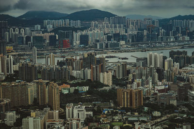 Aerial view of buildings in city against sky