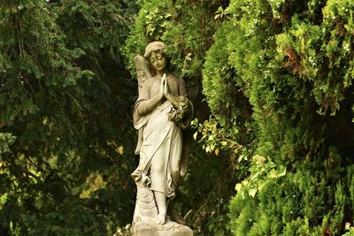 Statue against trees