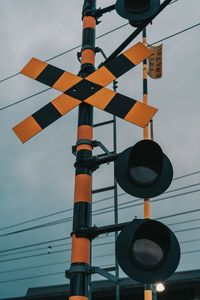 Low angle view of train sign against sky