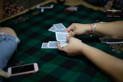 High angle view of woman hand on table