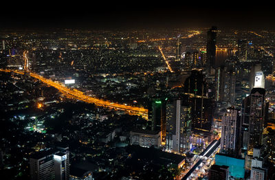 High angle view of illuminated city buildings at night