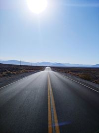 Road passing through landscape against sky