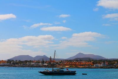 Boats in river with mountains in background