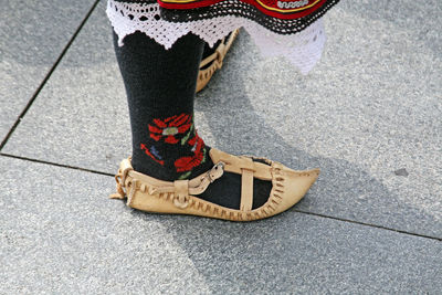 Low section of woman standing on tiled floor