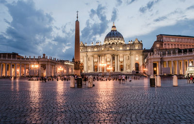 St peters basilica against sky in city at dusk