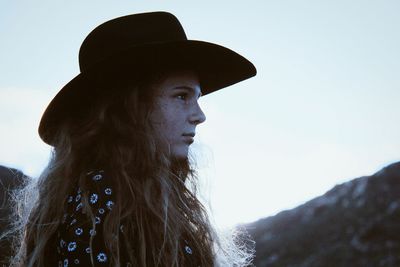 Close-up portrait of young woman against clear sky