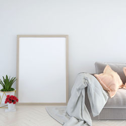 White flower vase on table against wall at home