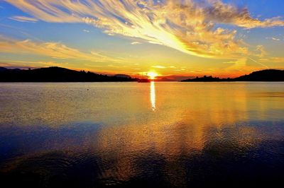 Scenic view of lake against romantic sky at sunset