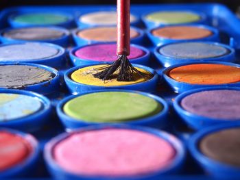 Close-up of colorful watercolor paints and paintbrush